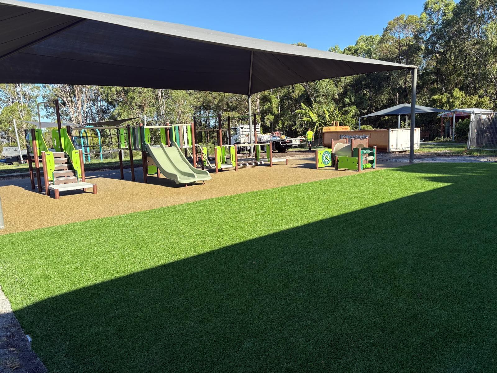 Completed playground at Aspect Hunter School - synthetic turf, inclusive play equipment and shade sails