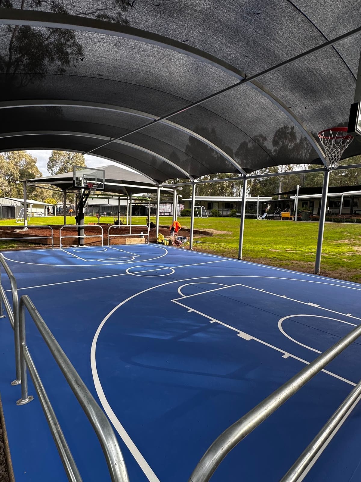 The covered court from the sideline, with edge protection running along the perimeter