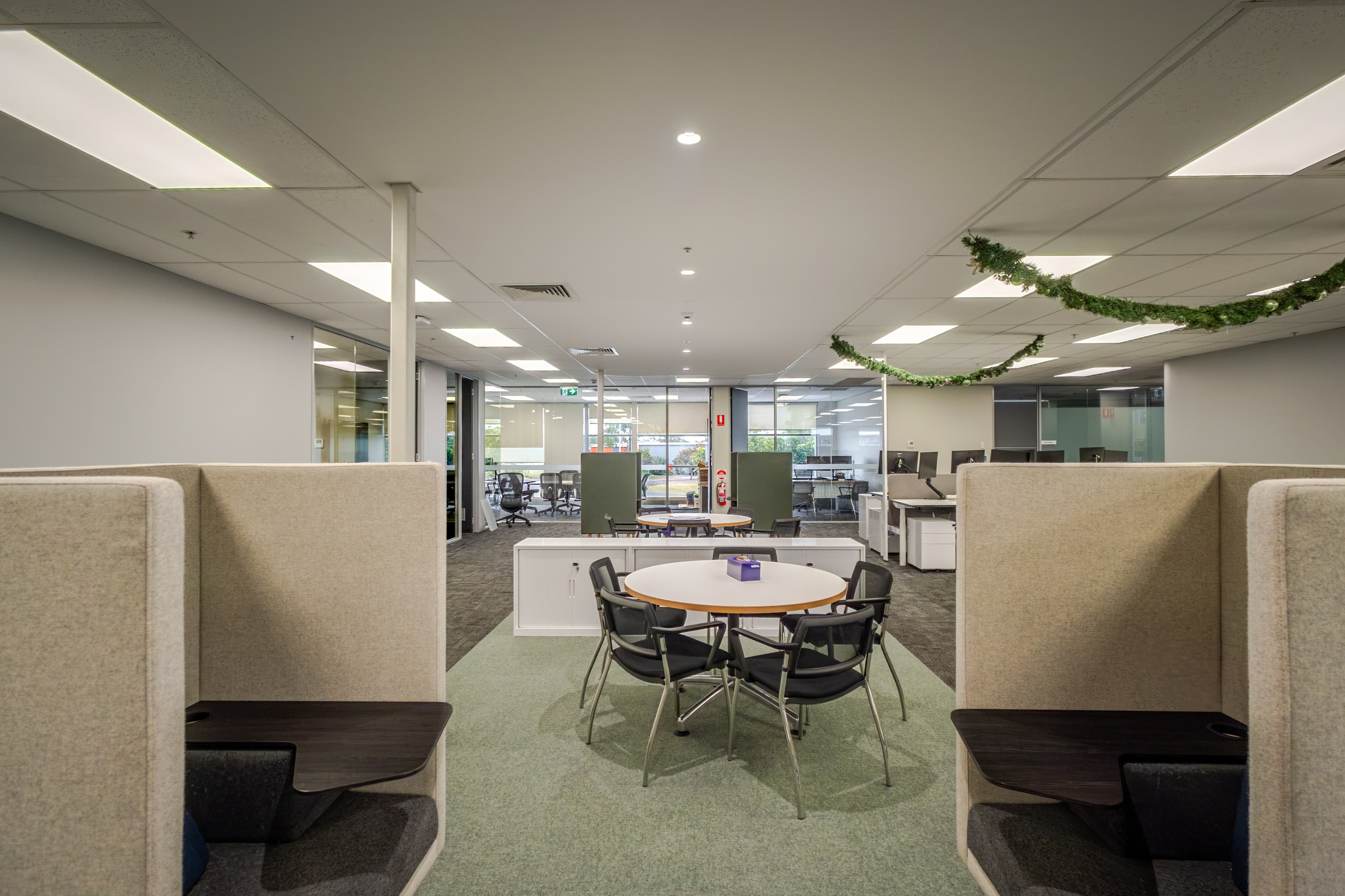 Open-plan collaborative workspace with booth seating